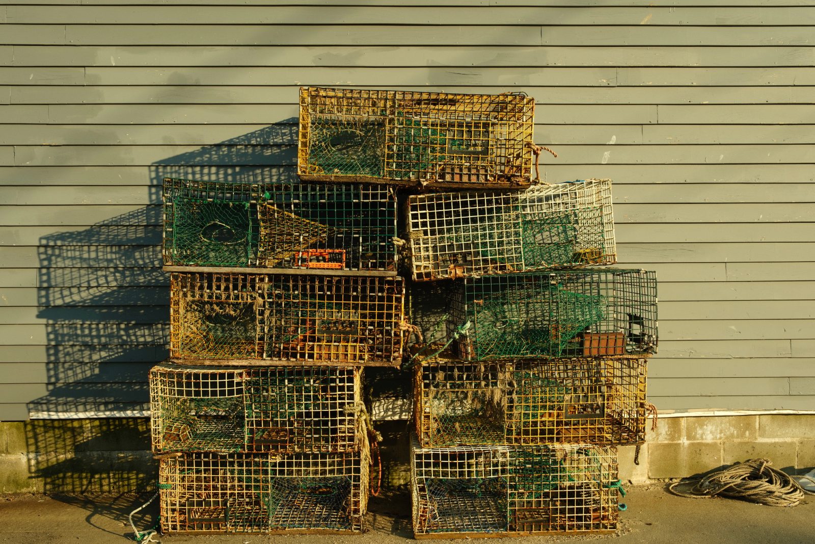 A stack of lobster traps outside a building.