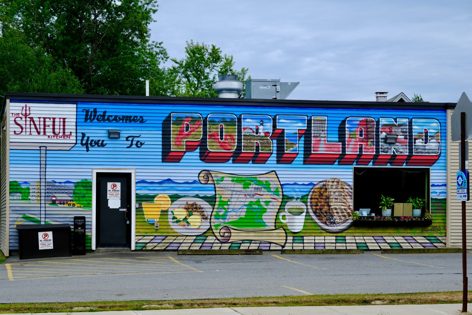 A mural covering the entire front of a restaurant called The Sinful Kitchen