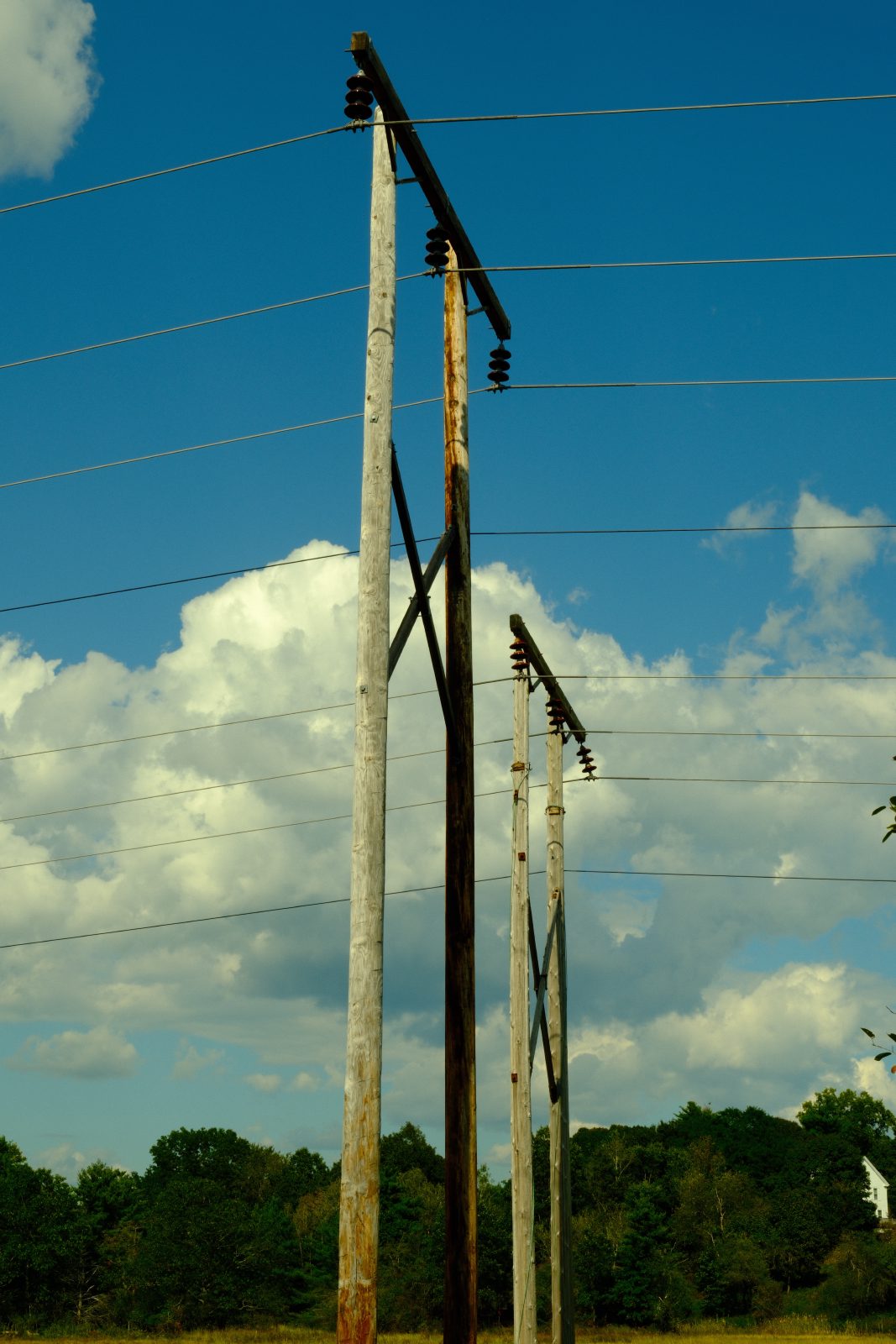 Power lines crossing left to right framing clouds