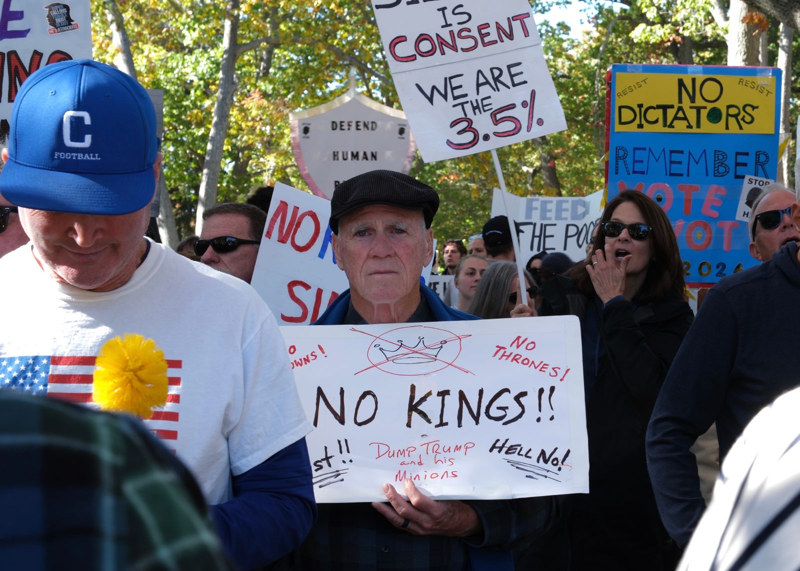 An older man that looks heartbroken at where we are holding a sign at a no kings protest