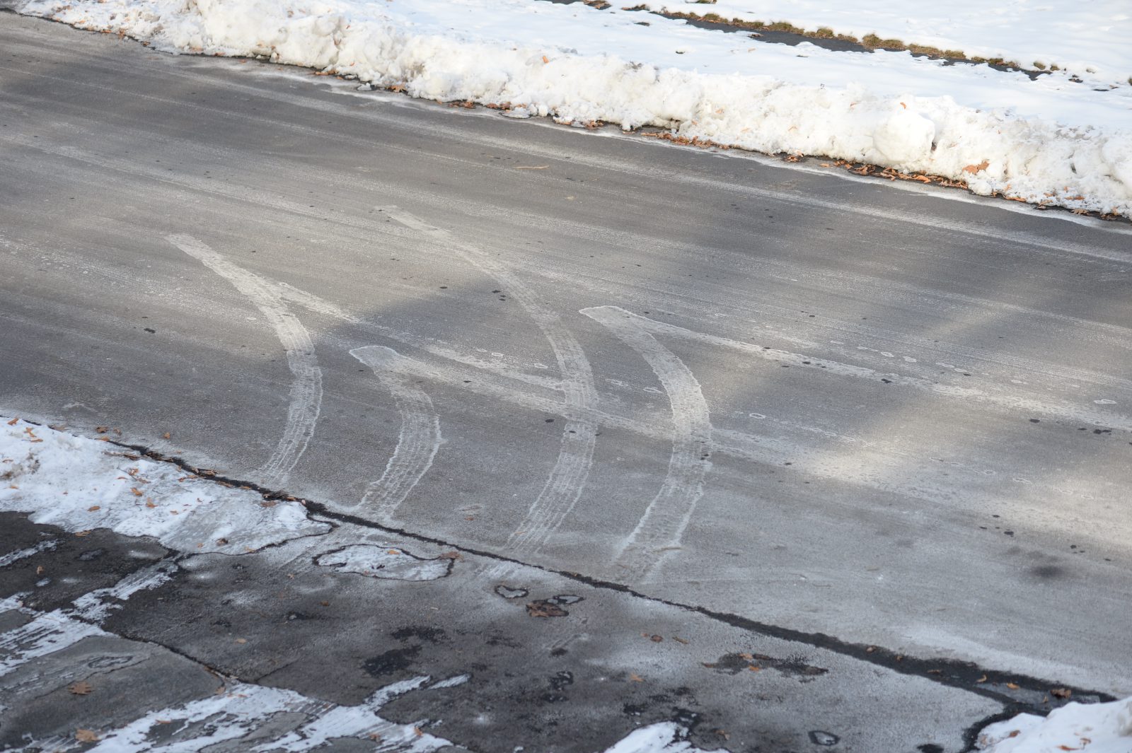 Salty tire tracks on asphalt