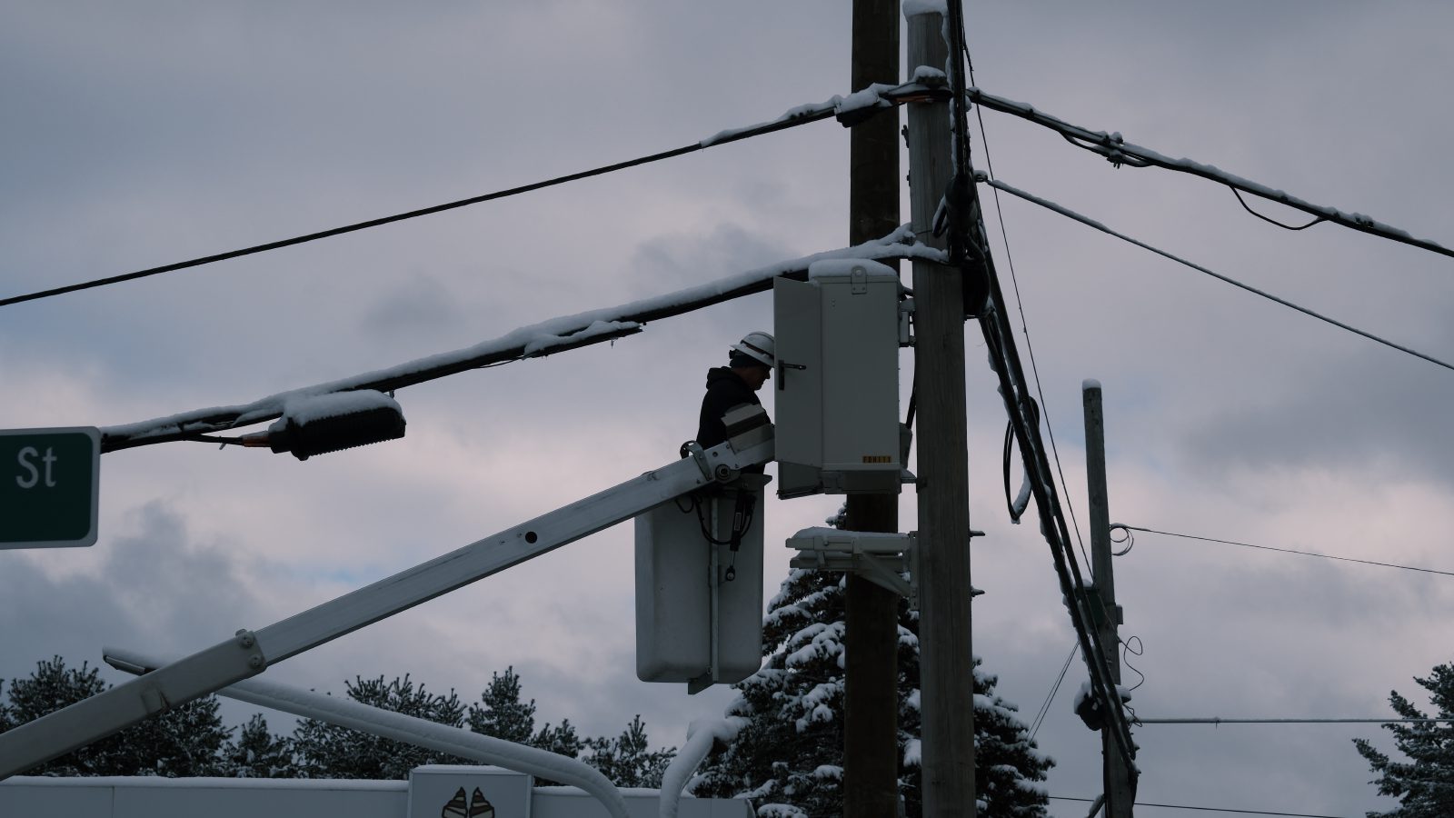 A faux silhouette of a man in a cherry picker bucket