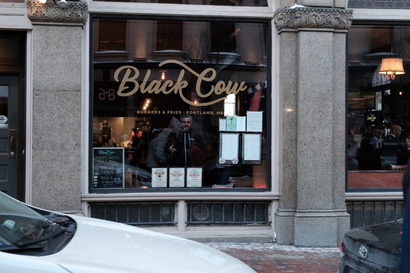 A resturant employee looking somewhat confused by the protests